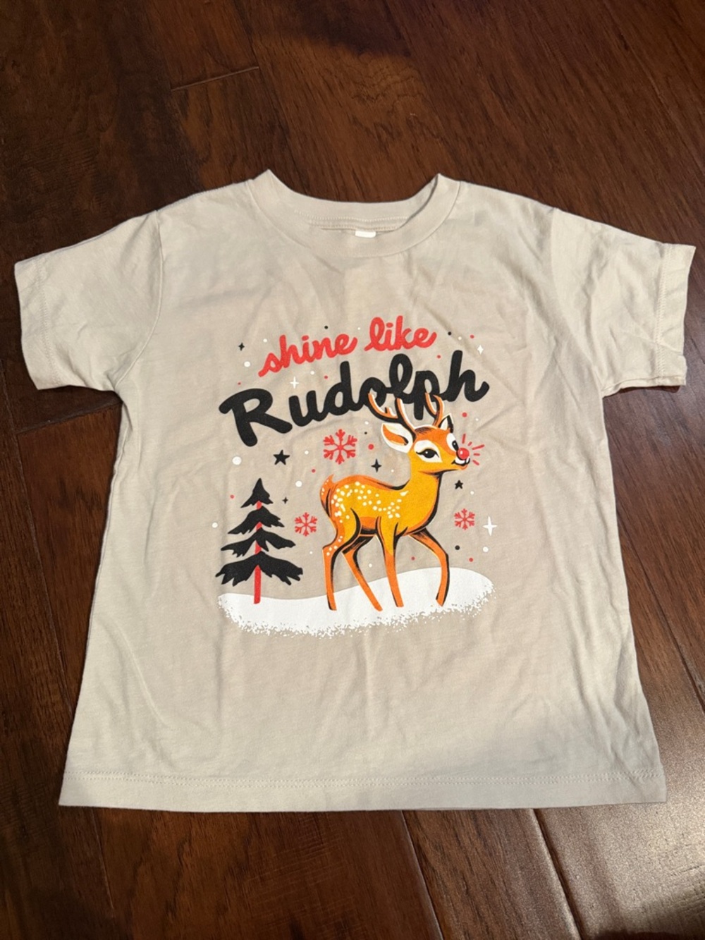 Bella Canvas Beige Kids 'Shine Like Rudolph' Graphic Tee with Orange Deer